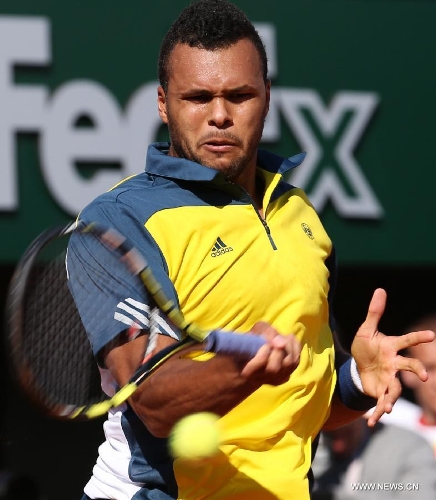 Jo-Wilfried Tsonga of France hits a return during the men's singles quarterfinal match against Roger Federer of Switzerland on day 10 of the French Open tennis tournament at the Roland Garros stadium in Paris June 4, 2013. Jo-Wilfried Tsonga won 3-0 to enter the semifinals. (Xinhua/Gao Jing) 
