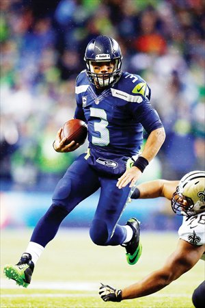 Russell Wilson of the Seattle Seahawks runs with the ball during an NFL game against the New Orleans Saints in Seattle on Monday. Photo: AFP