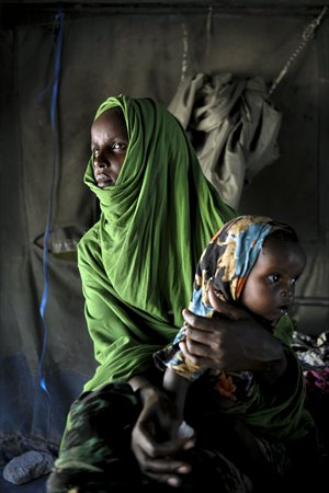 A handout photograph taken on Monday shows a Somali woman holding her child at a clinic in Mogadishu. Somalia's security forces launched a major security operation on Monday, searching for explosives and weapons, a day after a suicide attack by Islamist insurgents at Mogadishu's main court complex. Photo: AFP / AU-UN IST PHOTO / TOBIN JONES