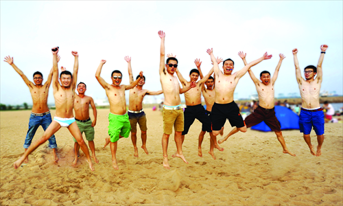  Employees from gay website danlan.org pose on the beach. 