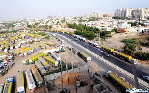 Oil tankers used to transport fuel to NATO forces in Afghanistan are seen at NATO supply terminal in southern Pakistani port city of Karachi, on July 3, 2012. Pakistan on Tuesday night announced that it is reopening land routes for NATO forces in neighboring Afghanistan after US Secretary of State, Hillary Clinton, apologized over the killing of 24 Pakistani soldiers in last November air strike, the country's Information Minister, Qamar-uz-Zaman Kaira said. Photo: Xinhua