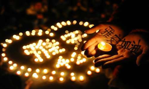 College students in Yangzhou, Jiangsu Province, hold a candlelight vigil for the quake-stricken city of Ya'an in Sichuan Province. The candles form the Chinese characters for the name of the city where the quake occurred on Saturday morning. Photo: IC