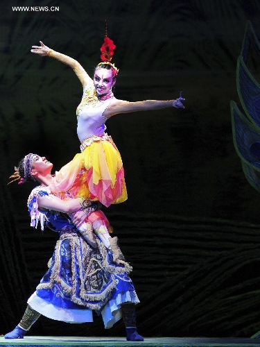 Dancers perform in the rehearsal of the musical Hundred-bird Dress in Nanning, capital of south China's Guangxi Zhuang Autonomous Region, April 27, 2013. The musical tells a legend of the Zhuang ethnic group about a young hero's sacrifice in protecting the homeland against an evil polluting power. (Xinhua/Liu Jun) 