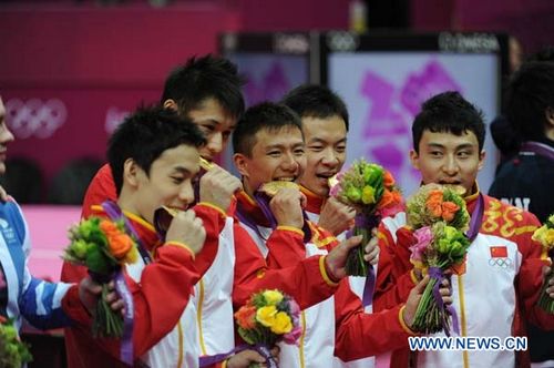 Chinese gymnasts celebrate after winning in Gymnastics Artistic men's team final contest, at London 2012 Olympic Games in London, Britain, on July 30, 2012. The Chinese team won gold medal. Photo: Xinhua