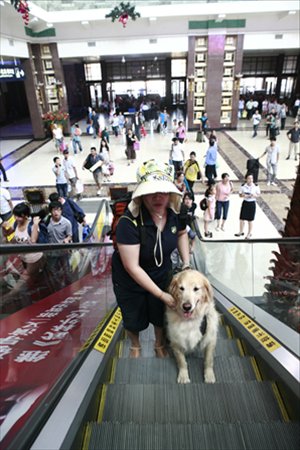August 15, 2012, Ping Yali and Lucky take a lift inside Beijing railway station