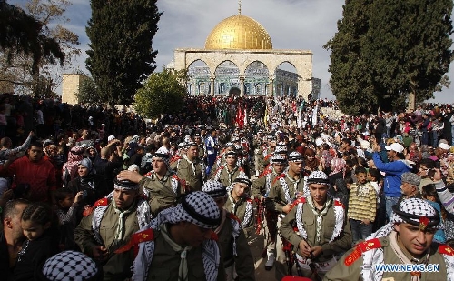 Palestinians take part in a ceremony commemorating the birth of Prophet Mohammed, known in Arabic as 