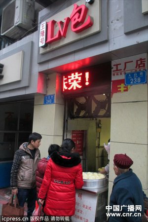Customers line up to buy steamed buns at the newly-renamed “LV Buns” stall in Wanzhou, Chongqing Municipality. Looking to cash in on China’s obsession with “Louis Vuitton”, owner surnamed Wang recently changed the name of his three square-meter stall from the unhip “Wanglonghao” in hopes his steamed buns become “as famous as LV.” Photo: cnr.cn