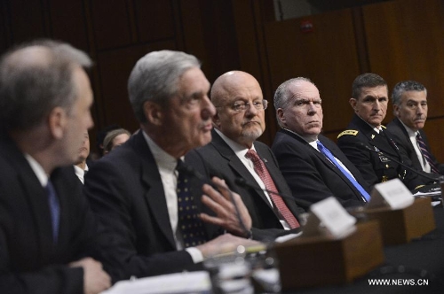 (L to R) National Counterterrorism Center Director Matthew Olsen, FBI Director Robert Mueller, Director of National Intelligence James Clapper, CIA Director John Brennan, Defense Intelligence Agency Director Michael Flynn, and Assistant Secretary of State for Intelligence and Research Philip Goldberg, testify before the Senate Select Intelligence Committee during a hearing on 