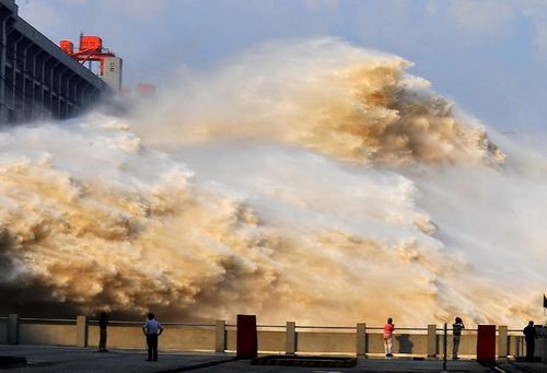 The Three Gorges Dam releases flood water through spillways in Yichang, Central China's Hubei Province, July 25, 2012. The biggest flood peak, of 71,200 cubic meters per second, in nine years smoothly passed the Three Gorges Dam as the water inflow into the dam receded on Wednesday morning. Photo: Xinhua