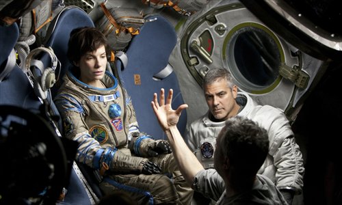 Inset: Gravity director Alfonso Cuarón speaks with stars Bullock and George Clooney. Photo: Courtesy of Yingxing Tianxia Entertainment 

