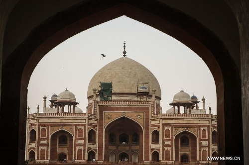 Photo taken on May 12, 2013 shows Humayun's Tomb in New Delhi, capital of India. Humayun's Tomb, located in east New Delhi, was built in 1569 to 1570 by Humayun's widow. As a precursor to the Taj Mahal, it stands on a platform of 12,000 square meters and reaches a height of 47 meters. The earliest example of the Persian influence in Indian architecture, the tomb itself is in the center of a large garden, surrounded by 12 hectares of gardens with pools joined by channels. The tomb brought Persian style to Delhi, but the two-tone combination of red sandstone and white marble is local, which shows the merging of different cultures. Humayun's Tomb was inscribed on the World Heritage List by the United Nations Educational, Scientific and Cultural Organization in 1993. (Xinhua/Zheng Huansong) 