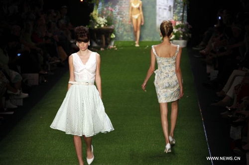 Models present creations by Austrian designer Lena Hoschek at the Spring/Summer 2014 Shows of the Mercedes-Benz Fashion Week, in Berlin, on July 2, 2013. (Xinhua/Pan Xu) 