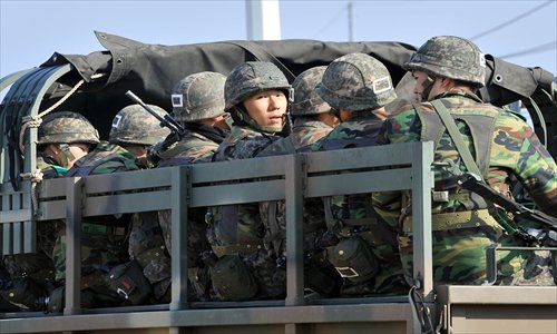 South Korean soldiers ride a military truck on the road leading to North Korea at a military checkpoint in the border city of Paju. South Korea and the US upgraded their coordinated military surveillance status on Wednesday, ahead of an expected mid-range missile launch by North Korea. Photo: AFP