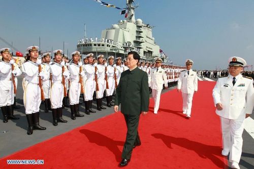 Chinese President Hu Jintao (C, front), also chairman of the Central Military Commission (CMC), and Premier Wen Jiabao (3rd R, front) attend the aircraft carrier handover ceremony held at a naval base in Dalian, Northeast China's Liaoning Province, September 25, 2012. China's first aircraft carrier 