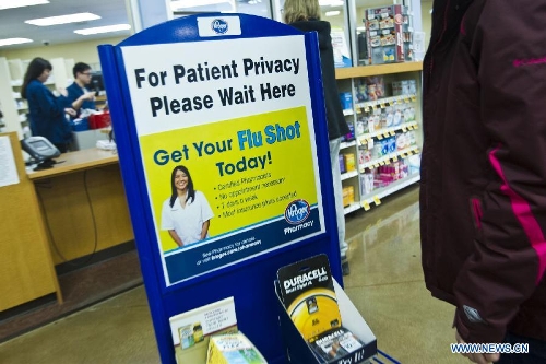 People wait to receive influenza vaccinations at a local supermarket pharmacy, in Ann Arbor, Michigan, the United States, Jan. 19, 2013. Four Michigan children have already died from influenza this season, according to the Michigan Department of Community Health. (Xinhua/Tony Ding) 