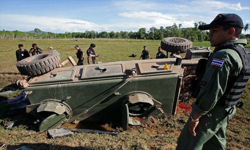Thai security forces inspect the site of a roadside bomb attack on an armored vehicle by suspected separatist militants, which killed two soldiers and injured six in Thailand's restive southern province of Pattani on Thursday.  More than 5,500 people have been killed in nine years of bloodshed in Thailand's Muslim-majority south near the border with Malaysia, with shadowy insurgent groups blamed for near-daily bombings and shootings. Photo: AFP