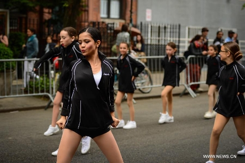 People participate in the annual Dance Parade in New York, on May 18, 2013. Over 200 dance groups showcasing 80 unique dance styles and cultures gathered from Broadway to the East Village on Saturday for the 7th Dance Parade in New York. (Xinhua/Niu Xiaolei) 