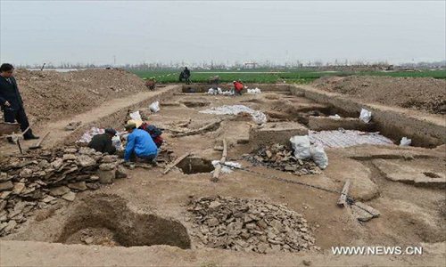 Archeological workers work at at a newly discovered ancient workshop site in Zibo, east China's Shandong Province, April 23, 2013. A bronze mirror workshop, dating from some 2,000 years ago in China's Han Dynasty (202 B.C.-220 A.D.), was discovered in Zibo and believed to be the first of its kind discovered in China. Photo: Xinhua