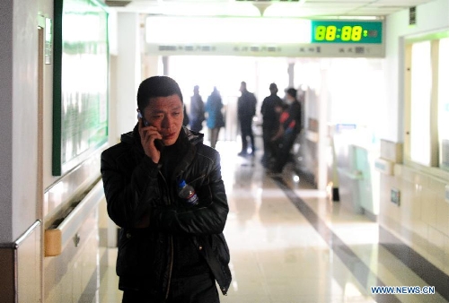 A relative of an injured miner is seen on the phone in a hospital in Baishan, northeast China's Jilin Province, March 30, 2013. Twenty-eight people were confirmed dead and 13 others injured in a gas blast at Babao Coal Mine in Jiangyuan District in the city of Baishan around 10:40 p.m. (1440 GMT) late Friday. The injuries of the 13 were not life threatening, said a spokesman with the provincial work safety and supervision bureau. Rescue work has been finished, and the cause of the accident is under investigation. (Xinhua/Xu Chang)