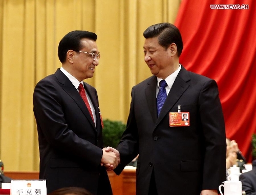 Xi Jinping (R) shakes hands with Li Keqiang at the fifth plenary meeting of the first session of the 12th National People's Congress (NPC) at the Great Hall of the People in Beijing, capital of China, March 15, 2013. Li Keqiang was endorsed as the premier of China's State Council at the meeting here on Friday. (Xinhua/Ju Peng)