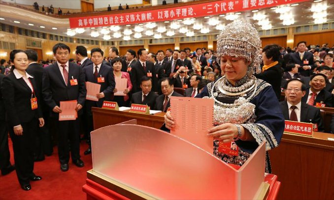 A delegate casts her ballot during the closing session of the 18th National Congress of the Communist Party of China (CPC) at the Great Hall of the People in Beijing, capital of China, Nov. 14, 2012. The congress started its closing session here Wednesday morning, at which a new CPC Central Committee and a new Central Commission for Discipline Inspection will be elected. Photo: Xinhua