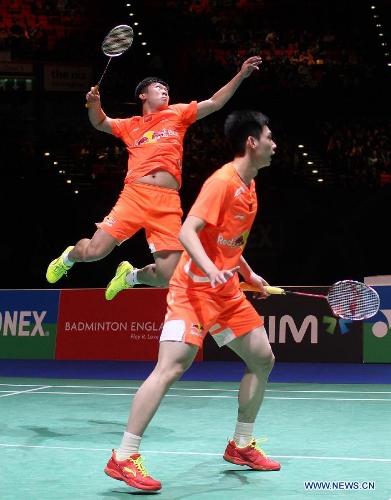 China's Liu Xiaolong/Qiu Zihan (L) compete during the men's doubles final against Japan's Hiroyuki Endo/Kenichi Hayakawa at the All England Open Badminton Championships in Birmingham, Britain, March 10, 2013. The Chinese pair won 2-0 to claim the title of the event.(Xinhua/Tang Shi) 