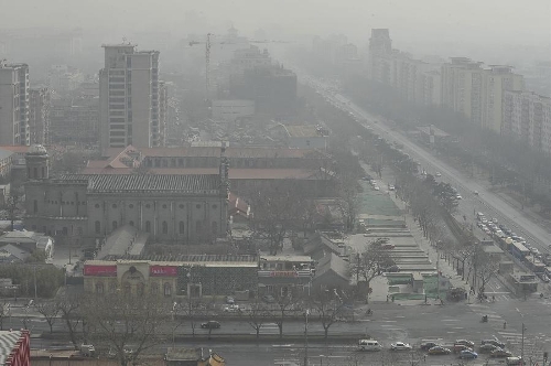 Sand and dust blanket buildings in Beijing, capital of China, March 9, 2013. A cold front brings strong wind as well as sand and dust to Beijing on March 9. (Xinhua/Lu Peng) 