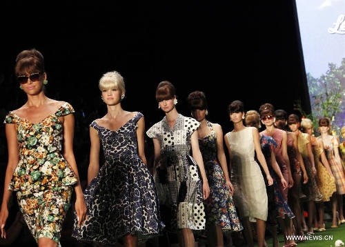 Models present creations by Austrian designer Lena Hoschek at the Spring/Summer 2014 Shows of the Mercedes-Benz Fashion Week, in Berlin, on July 2, 2013. (Xinhua/Pan Xu) 