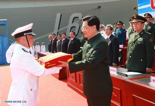 Chinese President Hu Jintao, also chairman of the Central Military Commission (CMC), endorses the flag of the People's Liberation Army (PLA) to the naval unit that receive the aircraft carrier 