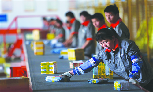 Express delivery workers distribute packages in Kunming, Yunnan Province. An anti-drug education campaign was launched in the city's express industry in June, attempting to increase awareness about security checks for deliveries. Photo: CFP