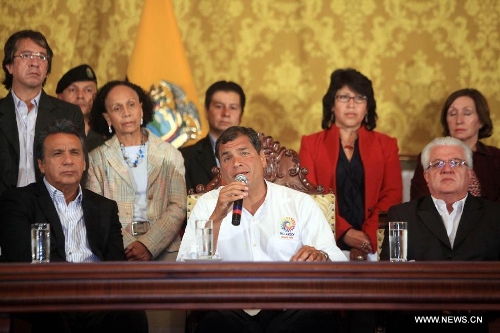 Ecuador's President Rafael Correa (C) gives a speech after the news of Venezuelan President Hugo Chavez's death was released, in Quito, Ecuador, on March 5, 2013. Rafael Correa expressed his condolences on Venezuelan President Hugo Chavez's death and declared three days of national mourning in Ecuador. Venezuelan President Hugo Chavez died on March 5. (Xinhua/Santiago Armas)