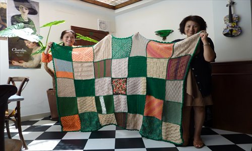 Members of the Shanghai Guild showcase a handmade woolen blanket. Photo: Coutesy of Niny Lam