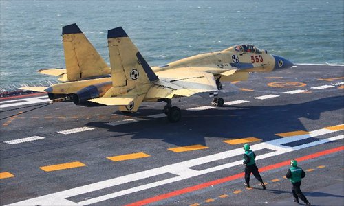 This undated photo shows a carrier-borne J-15 fighter jet ready to take off from China's first aircraft carrier, the Liaoning. China has successfully conducted flight landing on its first aircraft carrier, the Liaoning. After its delivery to the People's Liberation Army (PLA) Navy on Sept. 25, the aircraft carrier has undergone a series of sailing and technological tests, including the flight of the carrier-borne J-15. Capabilities of the carrier platform and the J-15 have been tested, meeting all requirements and achieving good compatibility, the PLA Navy said. Designed by and made in China, the J-15 is able to carry multi-type anti-ship, air-to-air and air-to-ground missiles, as well as precision-guided bombs. The J-15 has comprehensive capabilities comparable to those of the Russian Su-33 jet and the U.S. F-18, military experts estimated. Photo: Xinhua