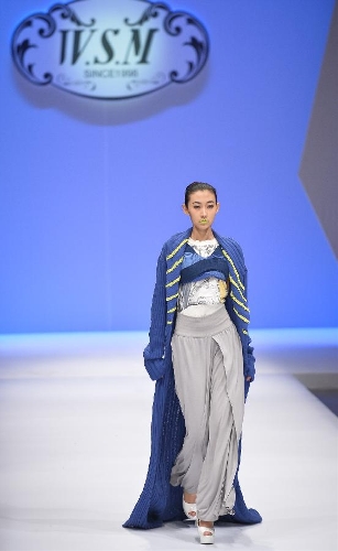 A model presents a creation in the WSM China Knitwear Fashion Design Contest 2013 during the China Fashion Week in Beijing, capital of China, March 26, 2013. The design by Sheng Lina from Fashion School & Engineering of Zhejiang Sci-Tech University won the championship of the contest. (Xinhua/Li Xin) 