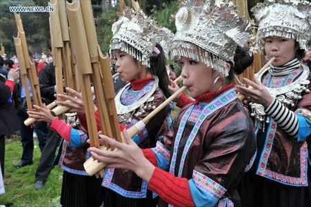 Women of the Dong ethnic group play the Sheng, a Chinese reed pipe wind instrument, during a celebration ceremony marking the 100th anniversary of the completion of Chengyang Fengshui Bridge held in Sanjiang Dong Autonomous county, South China's Guangxi Zhuang Autonomous Region, December 1, 2012. Built in 1912, the 77.76-meter-long bridge is famed for its combination of bridge, veranda and Chinese pavilion. (Xinhua/Lai Liusheng) 
