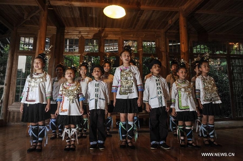 People sing folk song in Dimen Dong minority village in Liping County of southwest China's Guizhou Province, June 20, 2013. Dimen is a Dong minority village with about 2,500 villagers. It is protected properly and all the villagers could enjoy their peaceful and quiet rural life as they did in the past over 700 years. (Xinhua/Ou Dongqu)