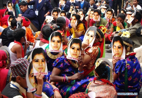 Indian students wear masks of Malala Yousufzai, a 15-year-old girl who was shot at close range in the head by a Taliban gunman in Pakistan, during a campaign to demand better budgetary allocation for health and education of Indian children in New Delhi, India, Feb. 2, 2013. (Xinhua/Partha Sarkar) 