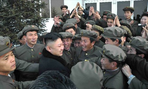 This photo provided by KCNA on Dec. 14, 2012 shows Kim Jong Un (C), top leader of the Democratic People's Republic of Korea (DPRK), celebrates with people after the successful launch of Kwangmyongsong-3 satellite at the Pyongyang General Satellite Control Command Center on Dec. 12, 2012. Kim Jong Un personally commanded Wednesday's satellite launch and observed the whole launching process, the official news agency KCNA reported earlier Friday.  Photo: Xinhua