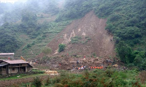 Rescuers search at the landslide site in the village of Zhenhe, located in Yiliang County of Zhaotong City in southwest China's Yunnan Province, October. 4, 2012. Nineteen people, including 18 students, were buried in a landslide here on Thursday. Eighteen people have been confirmed dead and one people remain missing. Photo: Xinhua