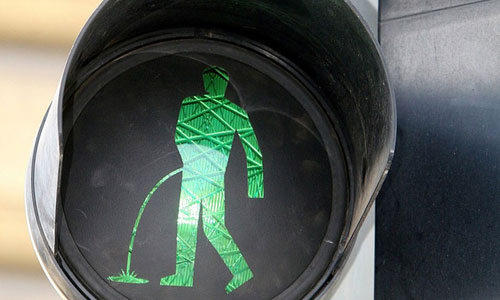 Altered traffic signs with red and green men appearing to lie down, drink and defecate appear in Prague in April 2012. The signs were deemed illegal and were removed by the authorities, Guerrilla art group Ztohoven claimed responsibility. Photo:ImagineChina