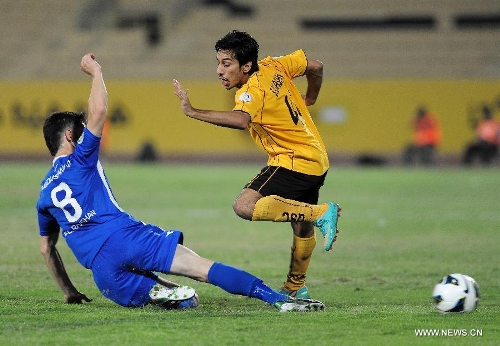 Saif Al Hassan (R) of Kuwait's Qadsia SC vies with Abdusamad of Tajikistan's Ravshan SC during their AFC Cup football match in Kuwait City, Kuwait, on April 3, 2013. Qadsia won the match 3-0. (Xinhua/Noufal Ibrahim) 
