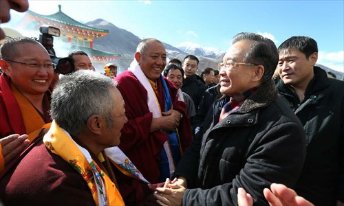 Chinese Premier Wen Jiabao (front R) talks with monks while visiting a monastery in Yushu Tibetan Autonomous Prefecture in northwest China's Qinghai Province, December 31, 2012. Wen paid a visit in quake-hit Yushu before New Year's Day to inspect the reconstruction work and extend New Year's greetings to the people there. Photo: Xinhua