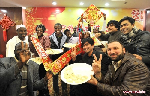 Overseas students present dumplings they made in an activity to celebrate the Chinese New Year at the Nanjing Agricultural University in Nanjing, capital of east China's Jiangsu Province, Feb. 4, 2013. More than 50 overseas students from over 20 countries and regions experienced Chinese traditional cultural activities with local students. (Xinhua)&nbsp; 