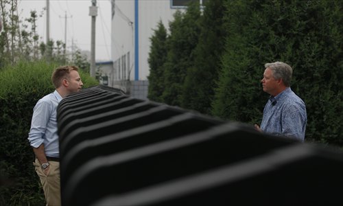Chip Starnes, the American executive who has been held by his workers in his plant in Huairou, Beijing for the past six days, answers questions from a reporter at the front gate on Tuesday. Photo: CFP