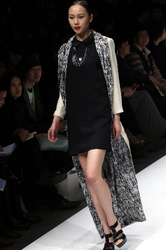 A model presents a creation designed by students from the Sino-French Institute of Fashion Designer in Shanghai University of Engineering Science during the first China Graduate Fashion Week in Beijing, capital of China, April 24, 2013. A total of 610 graduate students of fashion from 22 colleges will present their designs during the five-day event which kicked off on Wednesday. (Xinhua/Li Mingfang) 