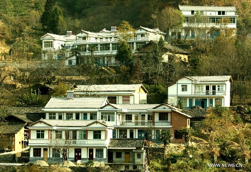 Photo taken on Nov. 20, 2010 shows newly-built houses in Songgou Village of Kangxian County in Longnan City, northwest China's Gansu Province. In the year of 2008, a massive earthquake occurred in Gansu's neighbouring province Sichuan, and Longnan was also battered by the disaster. During the past five years, a total of 3,905 reconstruction projects have been carried out in the city, where over 240,000 households have their houses rebuilt, and hundreds of schools and hospitals have been set up as well. (Xinhua/Wang Yaodong) 