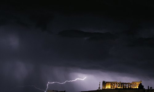 Lightning strikes by the Parthenon, on the Acropolis overlooking Athens during a thunderstorm that broke over the Greek capital on Sunday. Photo: AFP