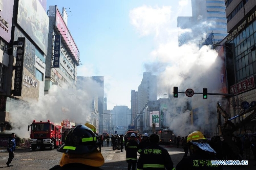 Rescuers work at the accident site after an explosion hit an underground passage in front of a shopping mall in Shenyang, capital of northeast China's Liaoning Province, March 4, 2013. It was not immediately known if there are any casualties. The shock wave of the blast at about 9 a.m. on Monday could be felt one kilometer away, local residents said. (Xinhua/Pan Yulong) 