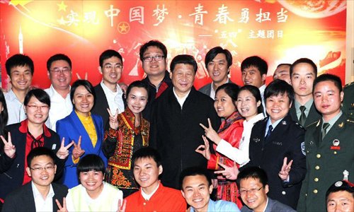 Chinese President Xi Jinping (C) poses for a photo with representatives of model youth before joining a discussion to mark the country's Youth Day on Saturday at China Academy of Space Technology in Beijing, capital of China, May 4, 2013. Xi on Saturday called on Chinese young people to contribute to the revitalization of the nation and 