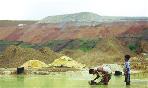 A Myanmese villager pans water for copper near the Sabal hill copper mine project in Monywa, northern Sagaing on September 14. Photo: AFP